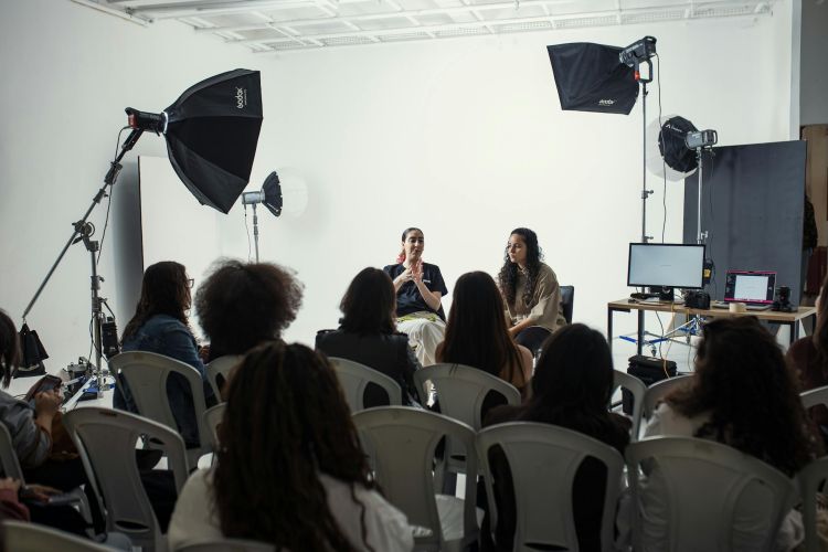 Unlock Success with Behind-the-Scenes Content Strategy 6 Behind the scenes camera setup capturing a speaker to repurpose event footage for future campaigns