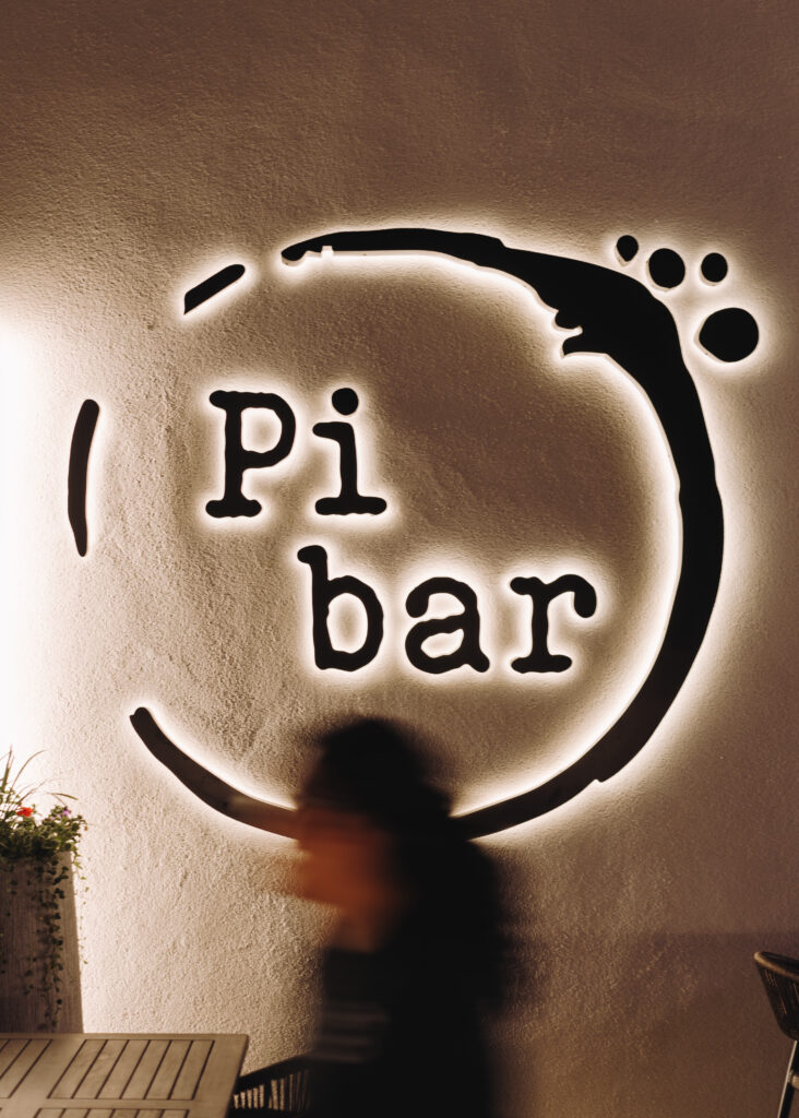 Pi Bar's glowing exterior sign at night, captured by Luma Creative, a San Francisco social media marketing agency