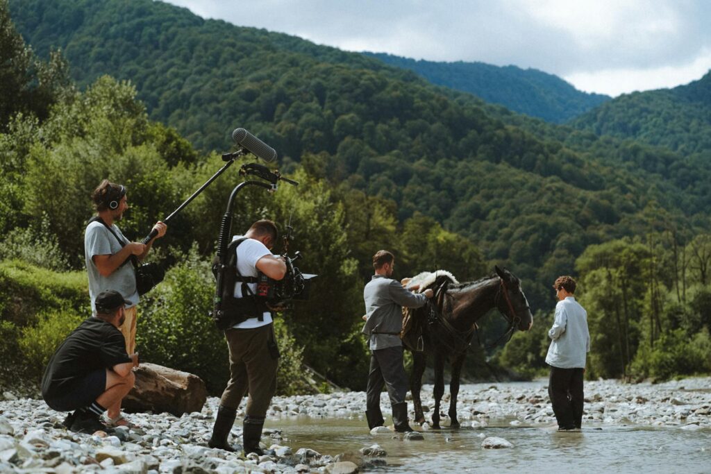 managing freelancers of production crew on location in the wilderness near a horse